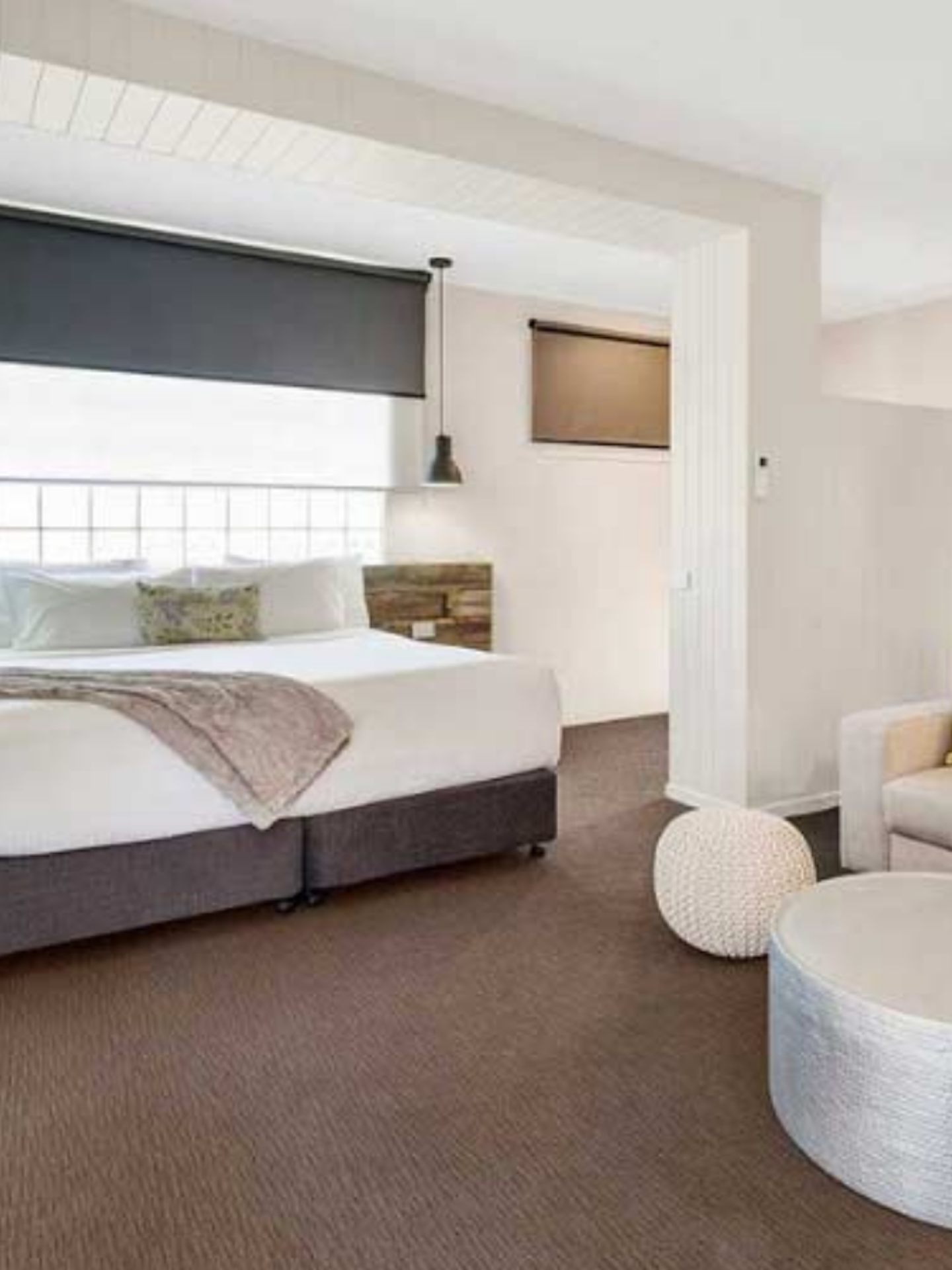 modern hotel room with bed and lounge area