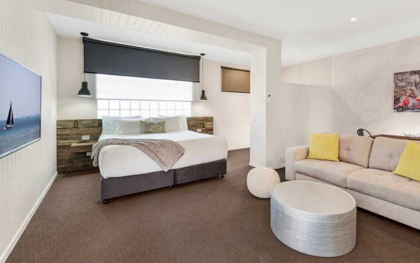 modern hotel room with bed and lounge area