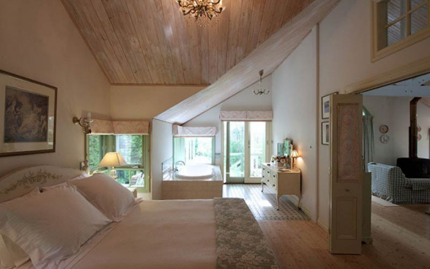 king sized bed in white and timber bedroom