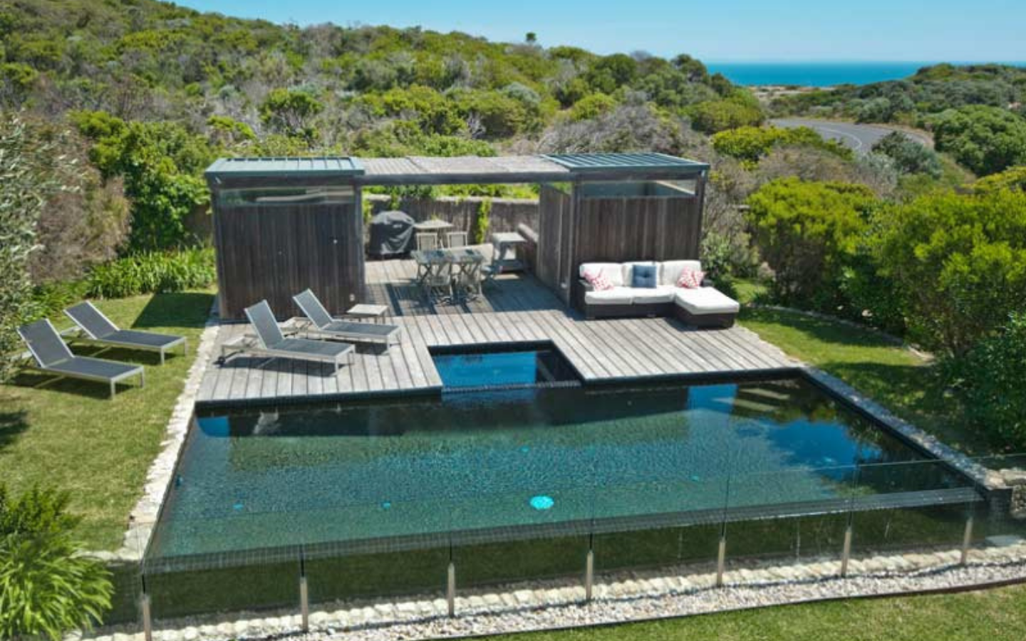 aerial view of spectacular beach house with infinity pool and deck set in teatree