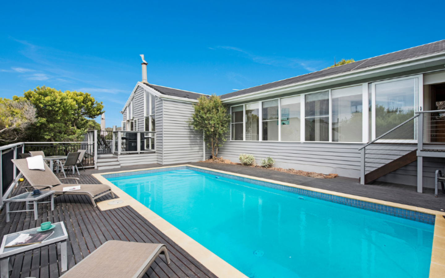 long inground pool and deck of beach house