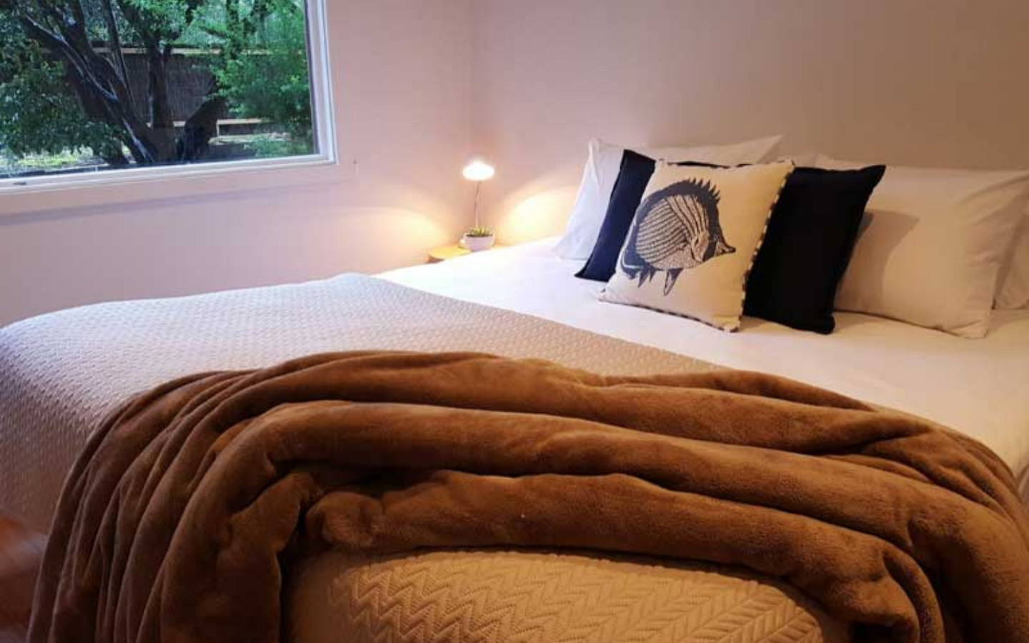 lovely guest bedroom with view of nature outside window