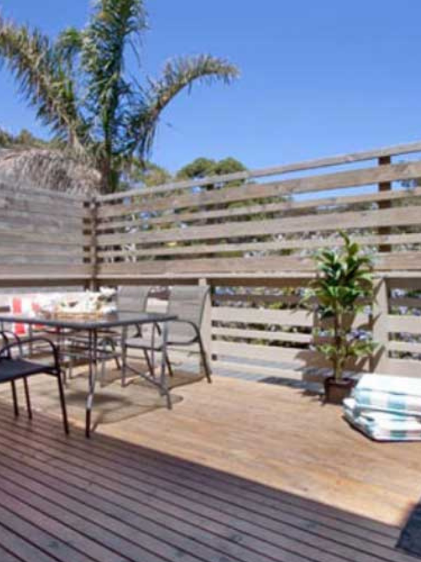 sunny deck with outdoor setting and barbeque