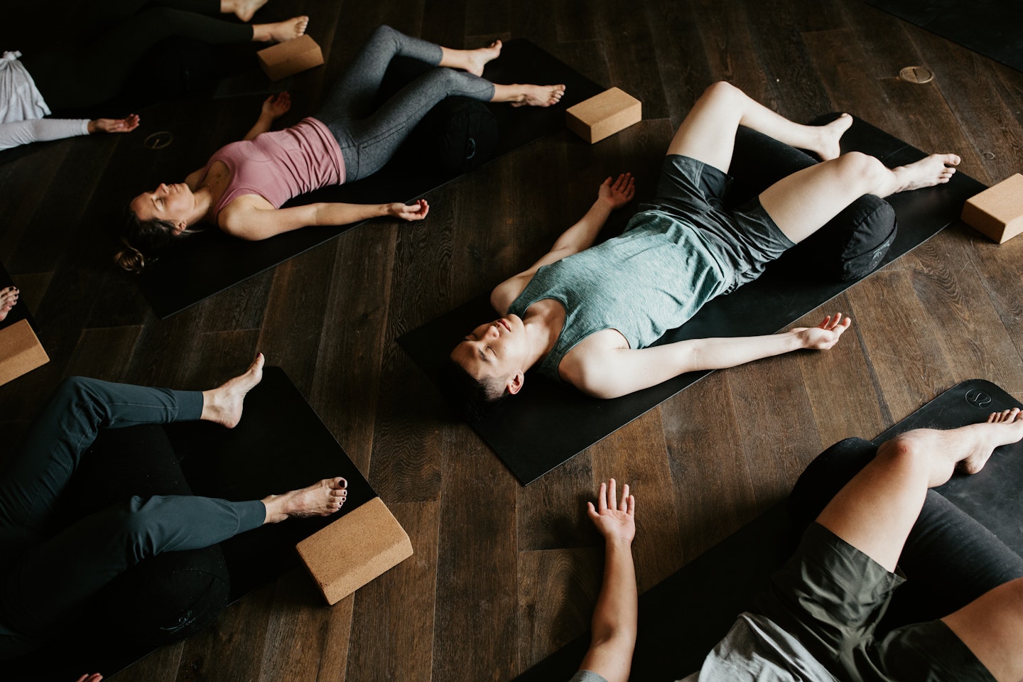 yoga group lying in savasana pose