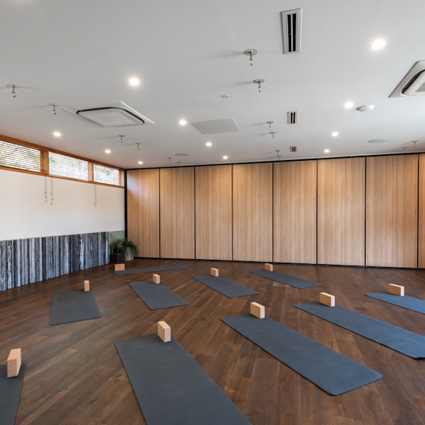 large indoor space set up with yoga mats and blocks for a group
