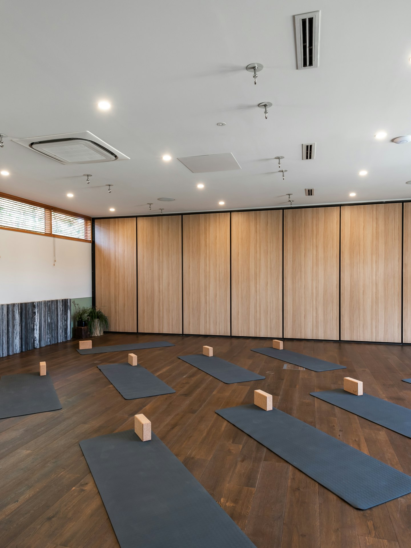 large indoor space set up with yoga mats and blocks for a group