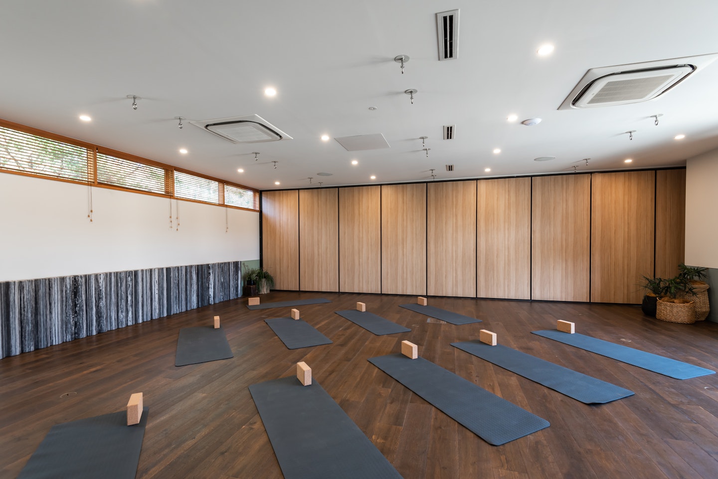 large indoor space set up with yoga mats and blocks for a group