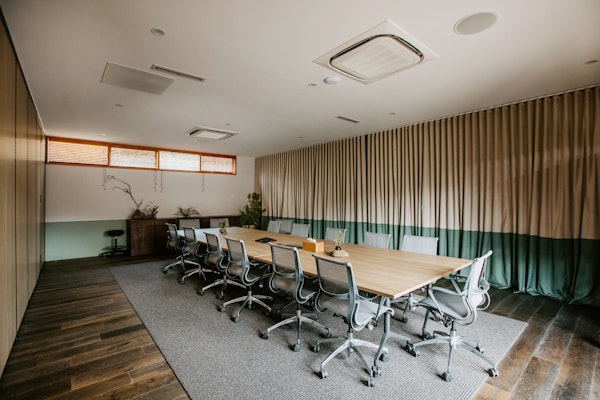 boardroom set up with one long table and chairs around