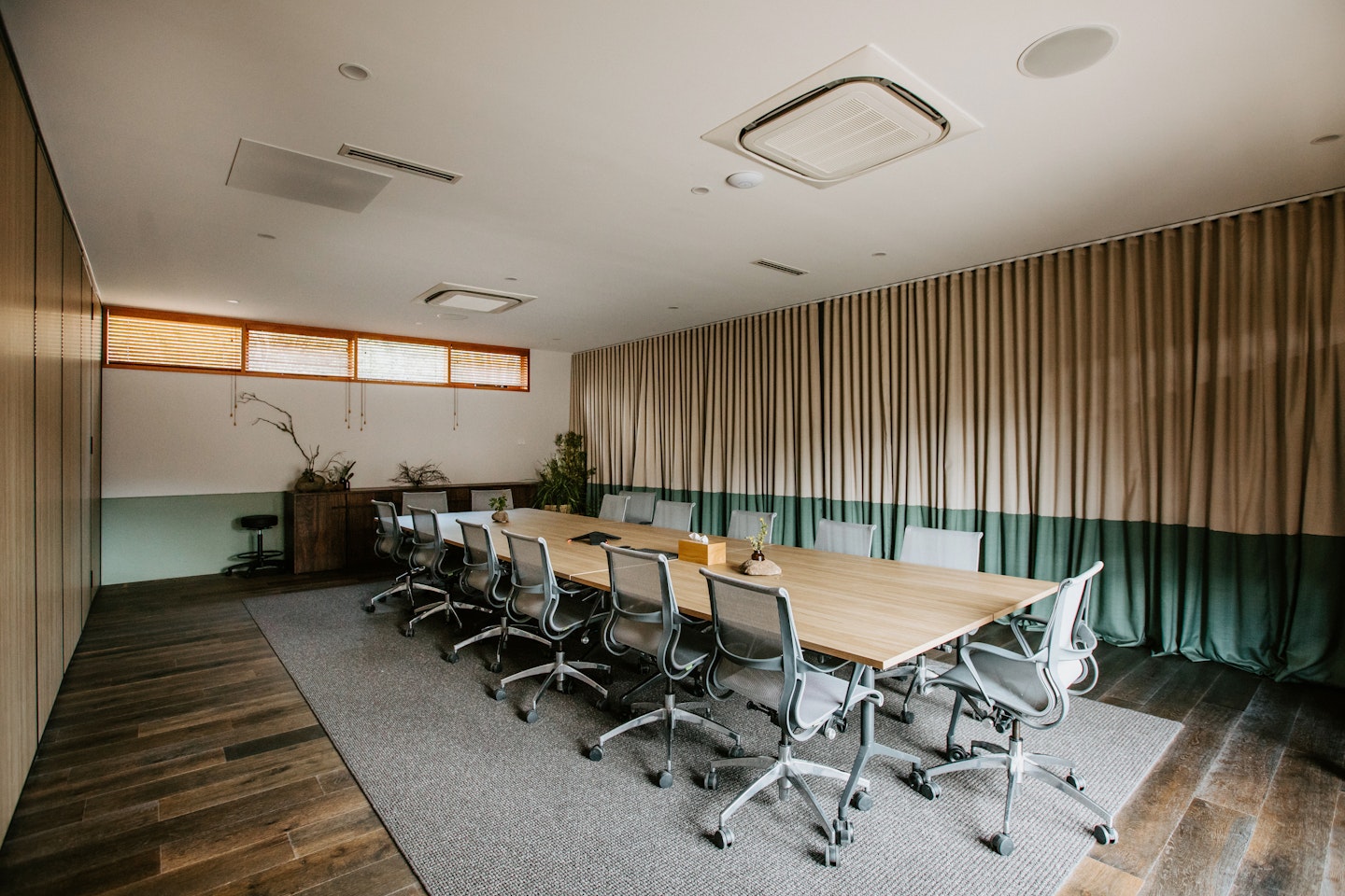 boardroom set up with one long table and chairs around