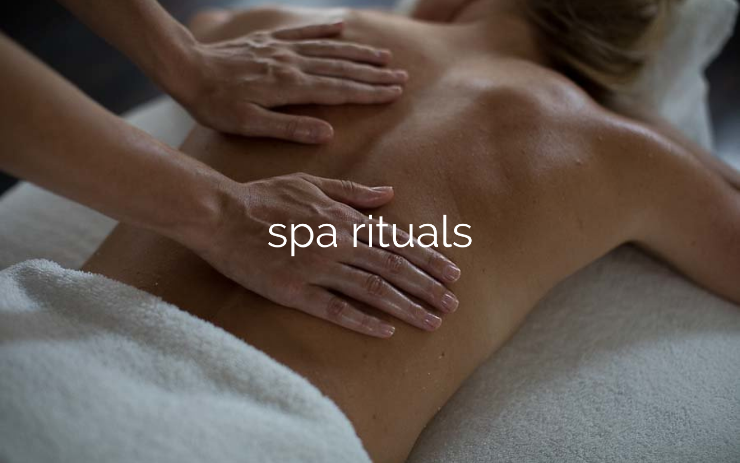 two hand massaging a bare back during a treatment