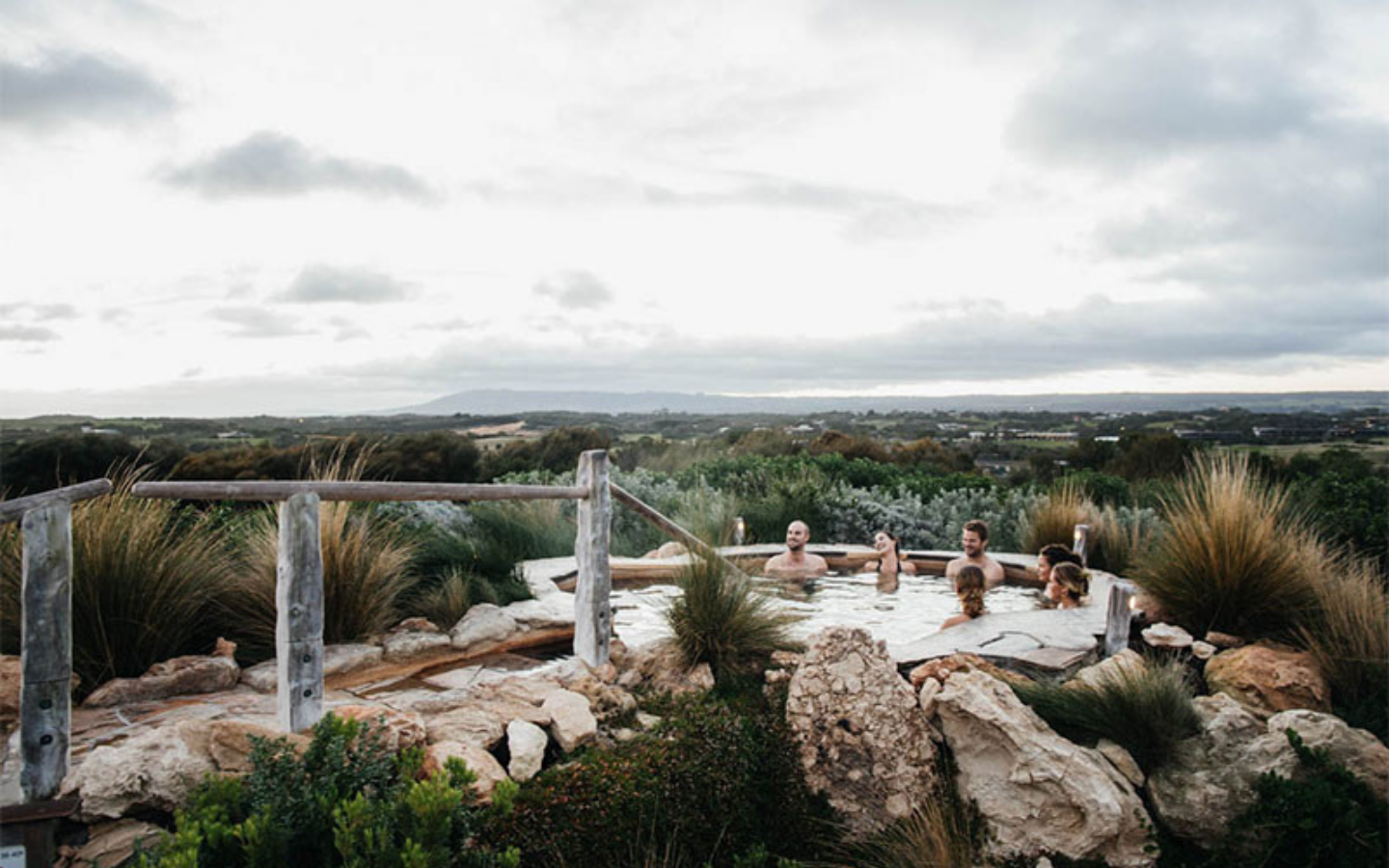 group of people relaxing in hilltop pool