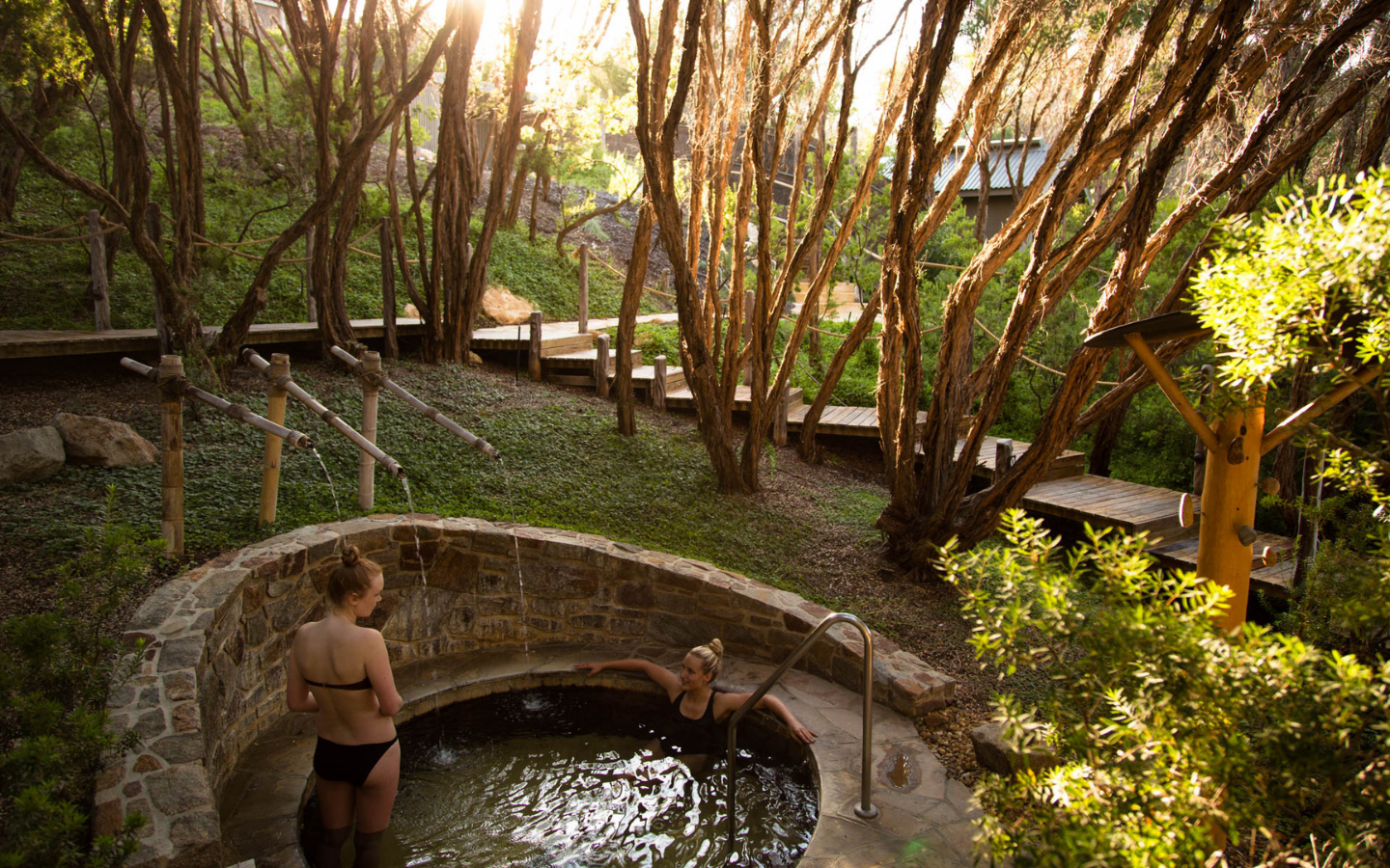 friends in a pool with massaging showers