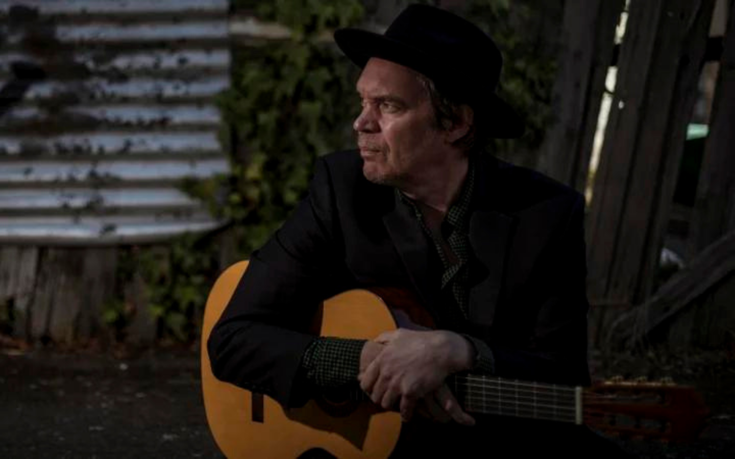 man sitting with a guitar