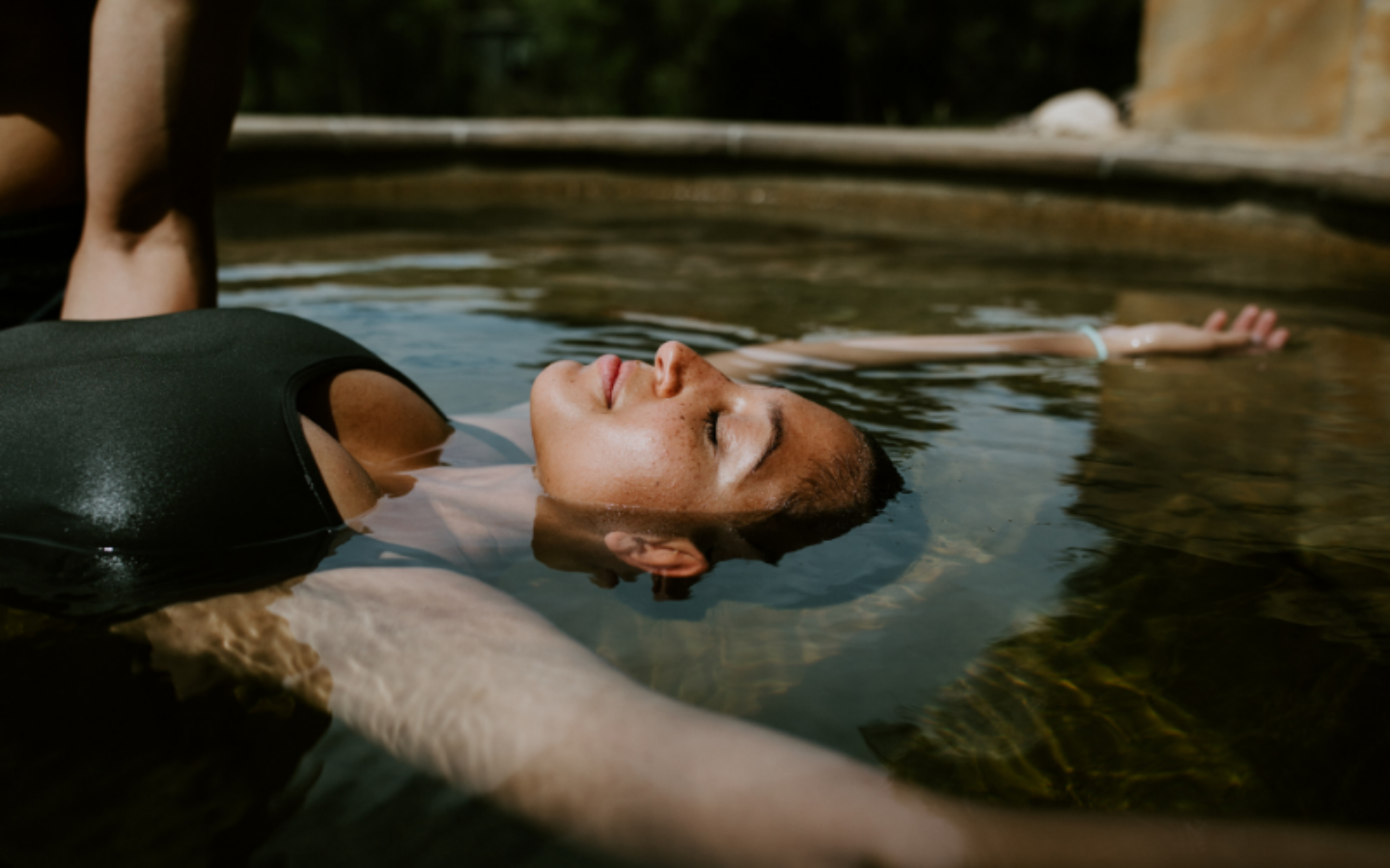 girl floating in pool