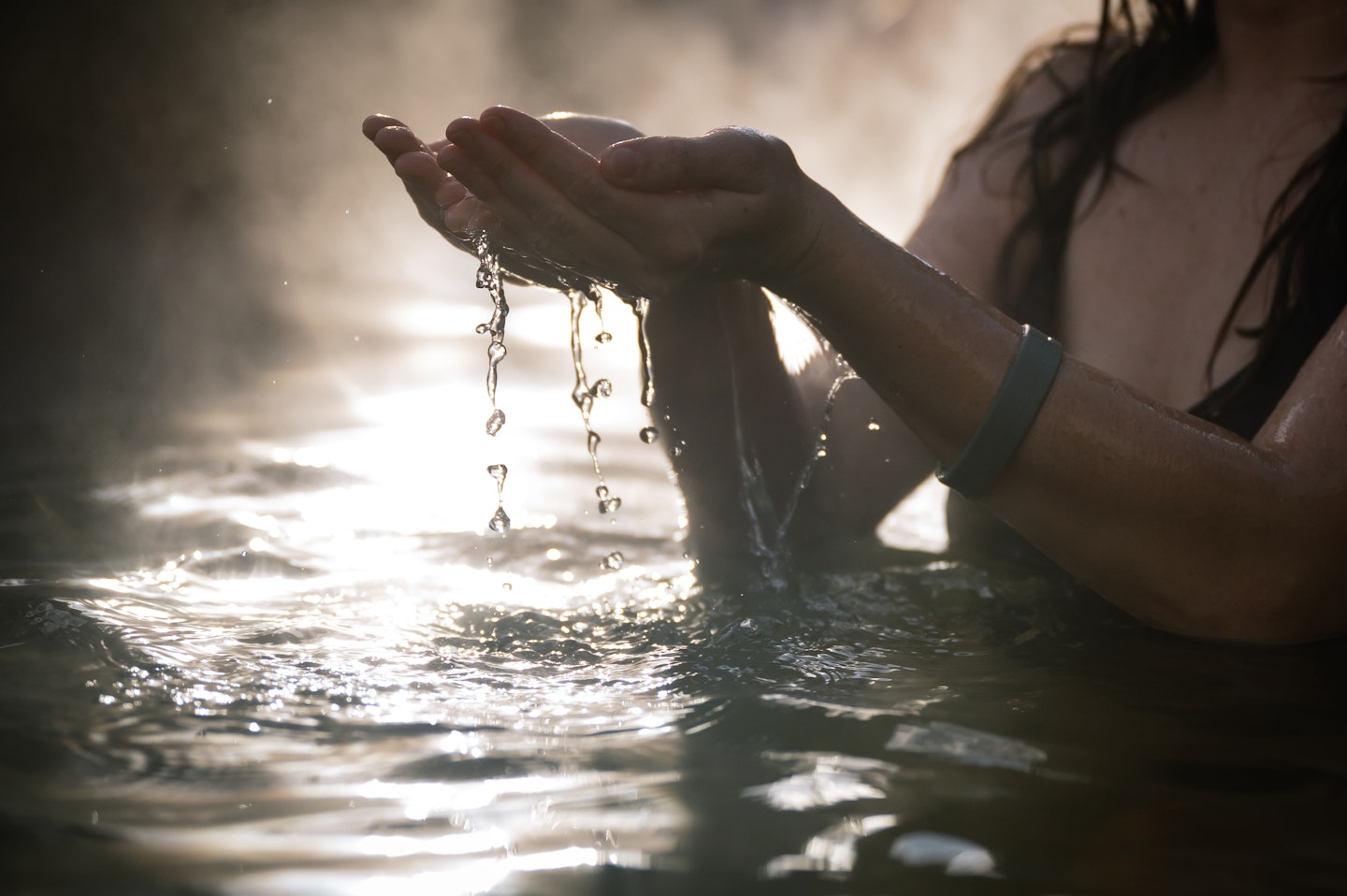hand skimming through water