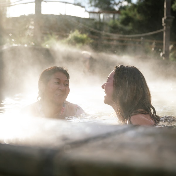 two women laughing in a pool