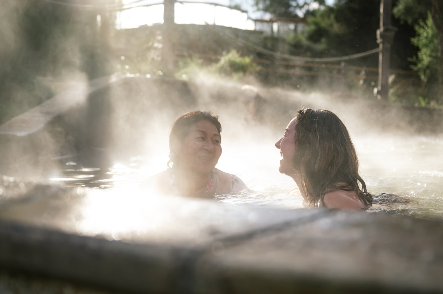 two women laughing in a pool