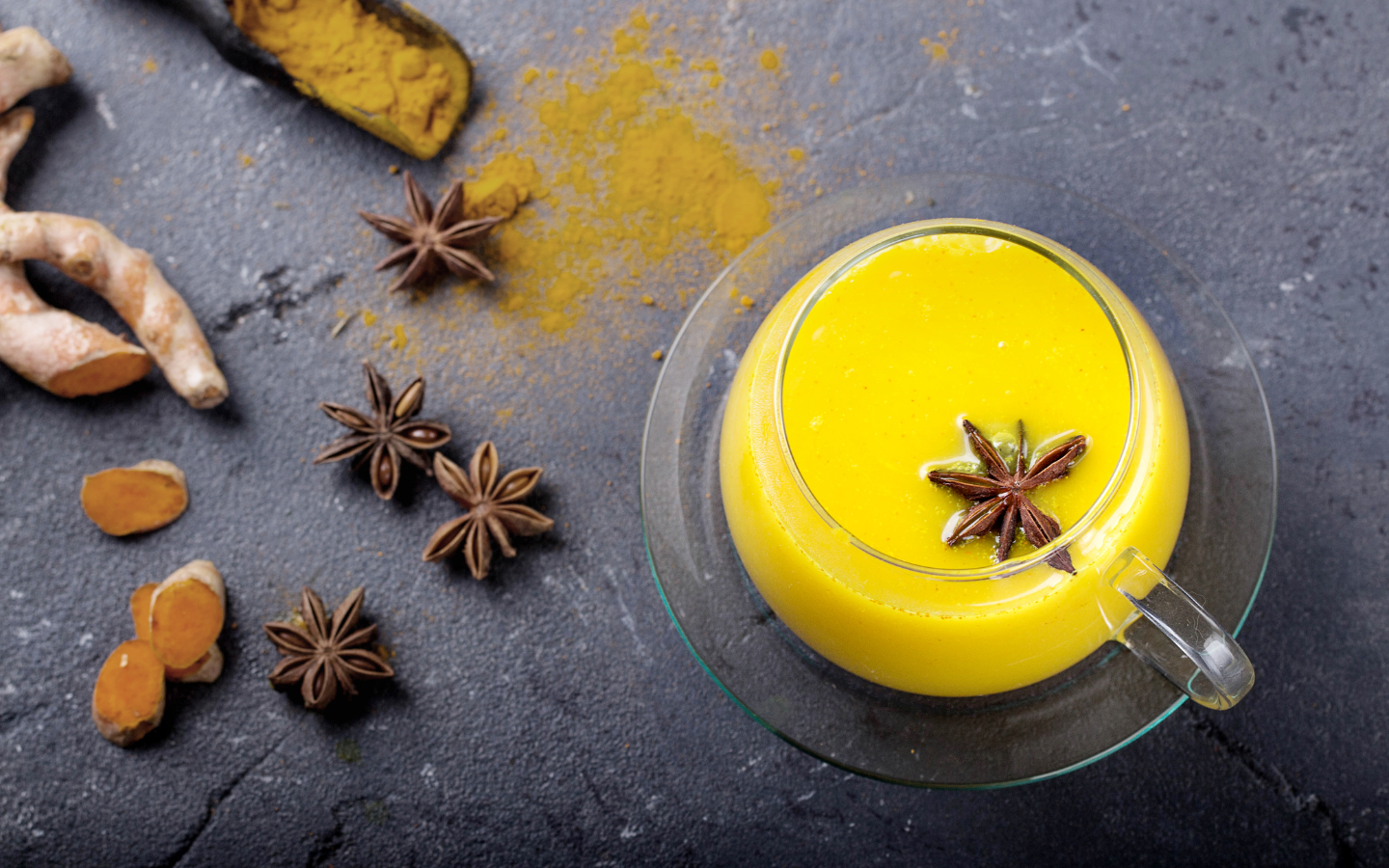 a mug of turmeric milk with spices to the side