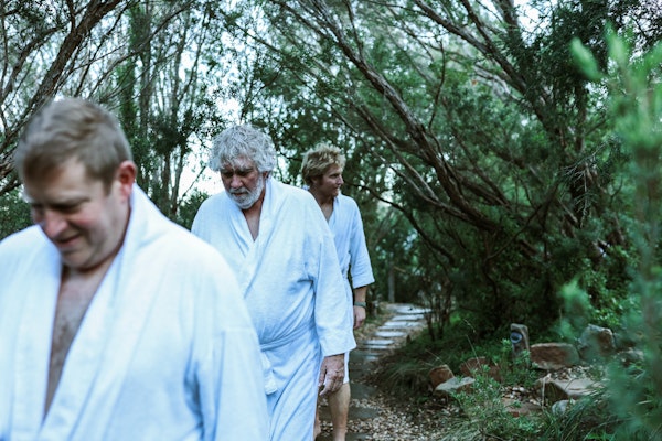 a group men walking through trees