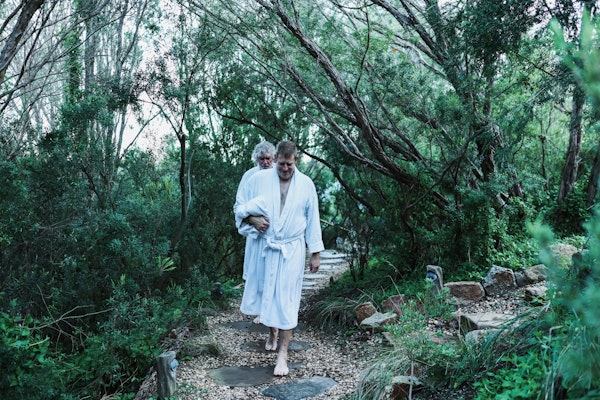 men walking through the bath house