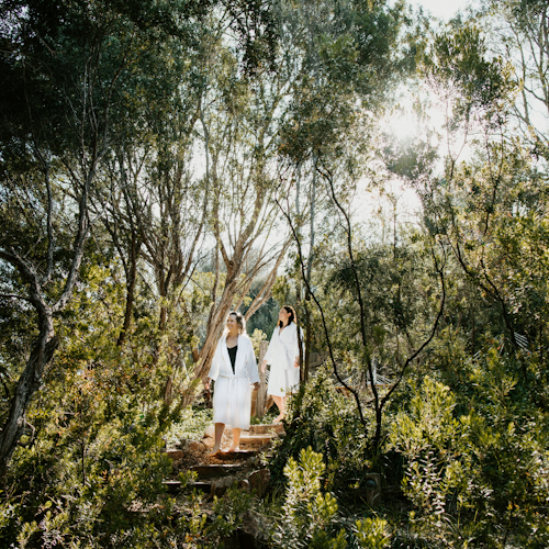 Two women walking down the stairs in the bathing gully