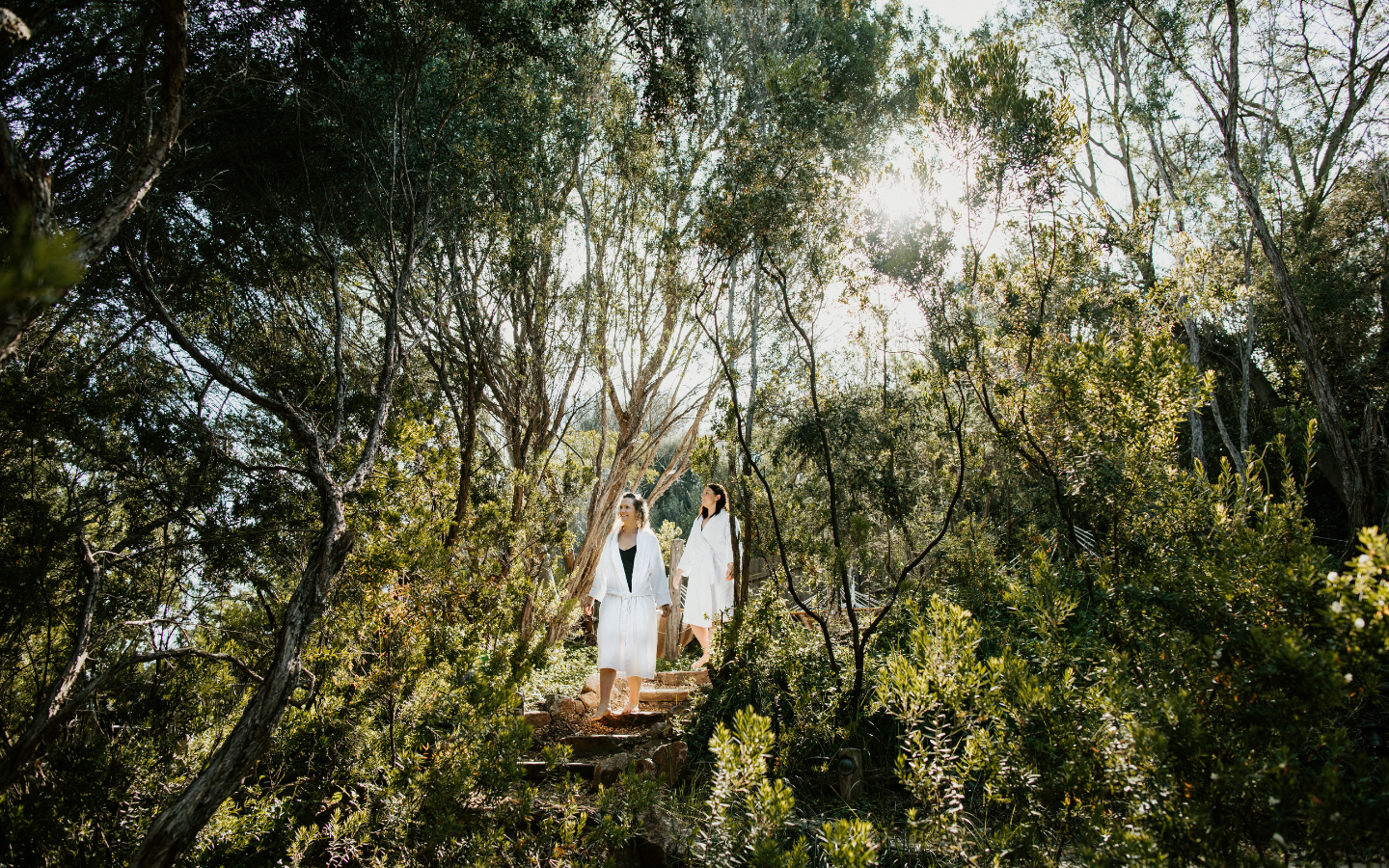 Two women walking down the stairs in the bathing gully