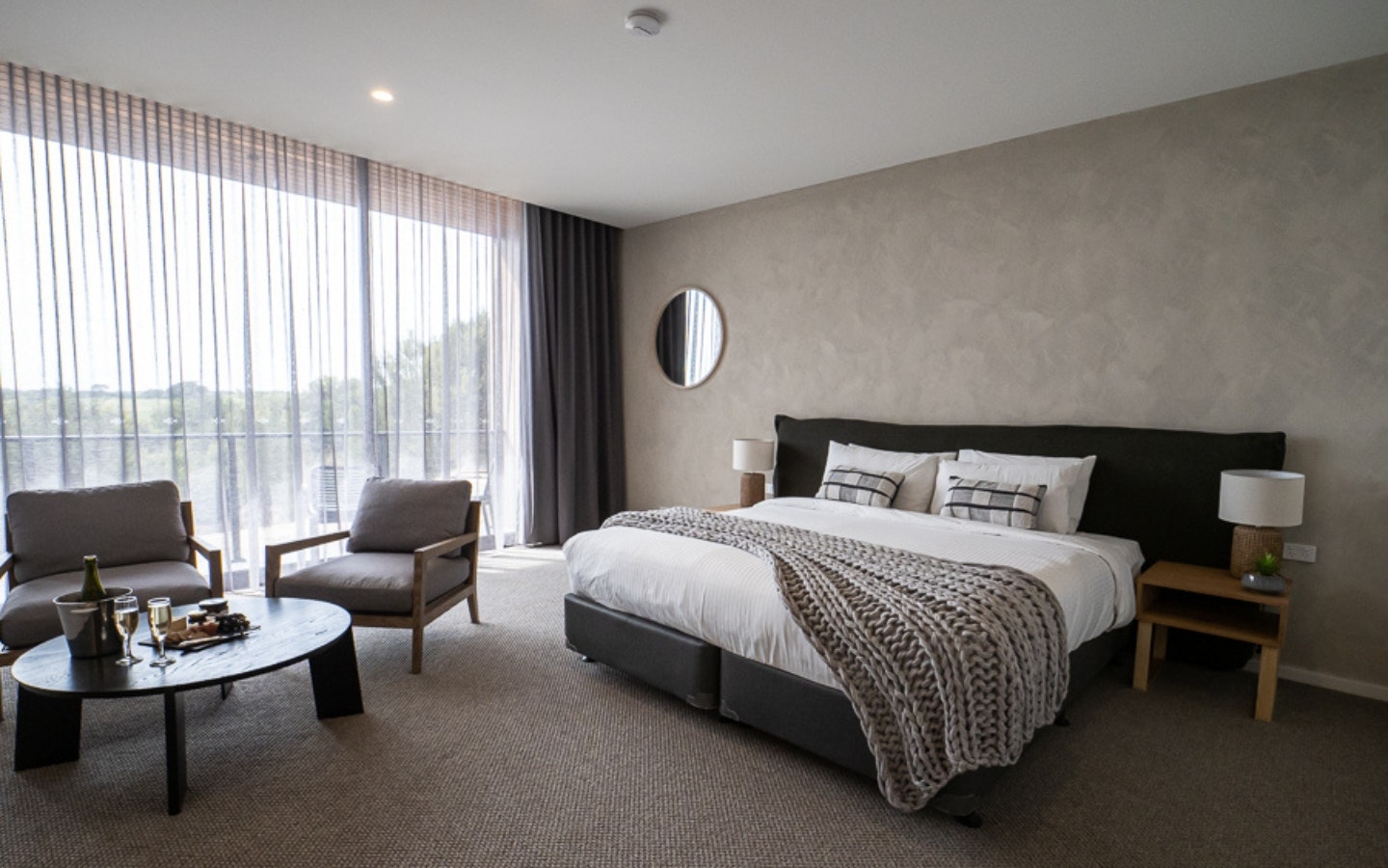 a grey room with a king size bed