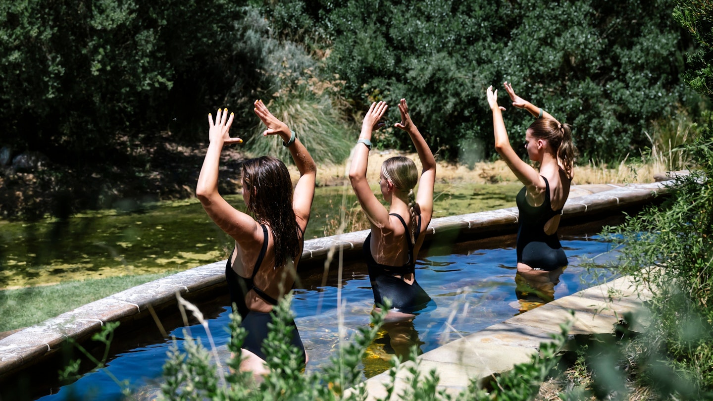 a group of girls doing hot springs yoga