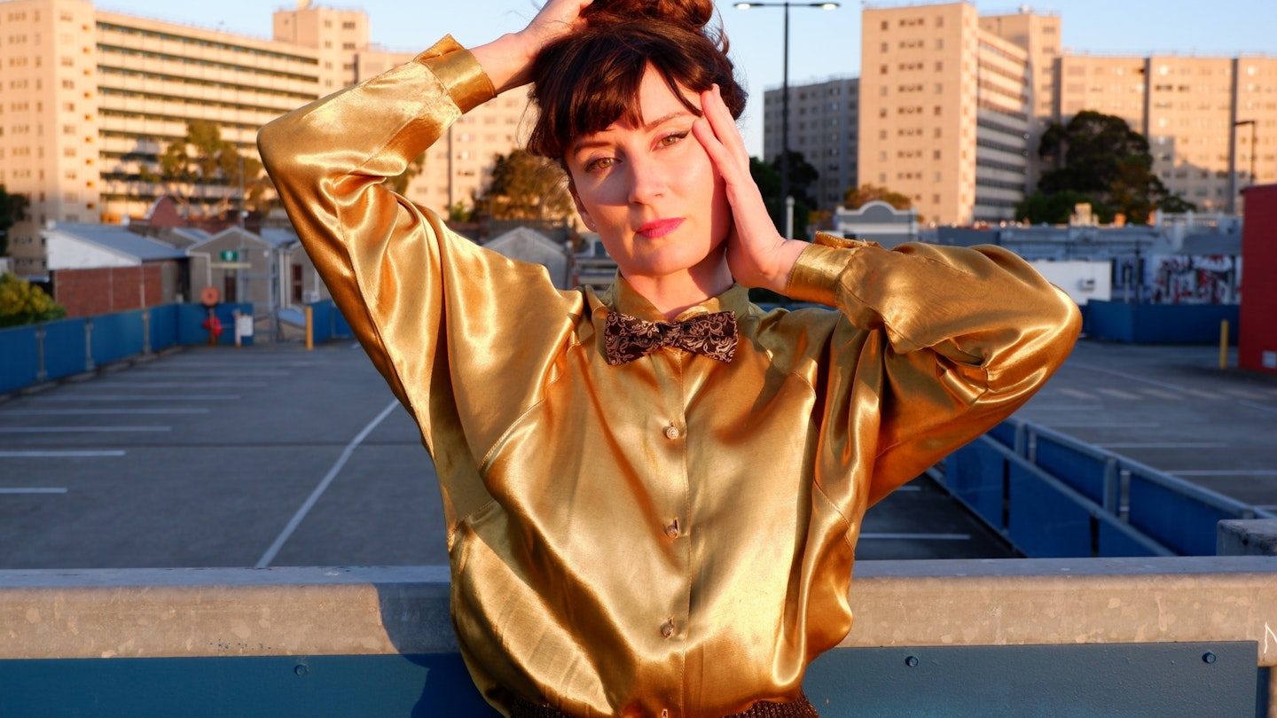 a girl in a gold blouse