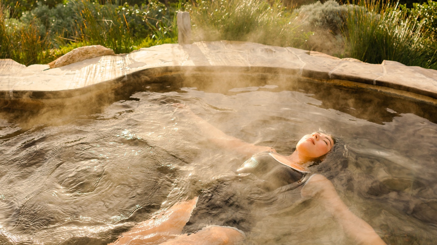 a girl floating in the hilltop pool