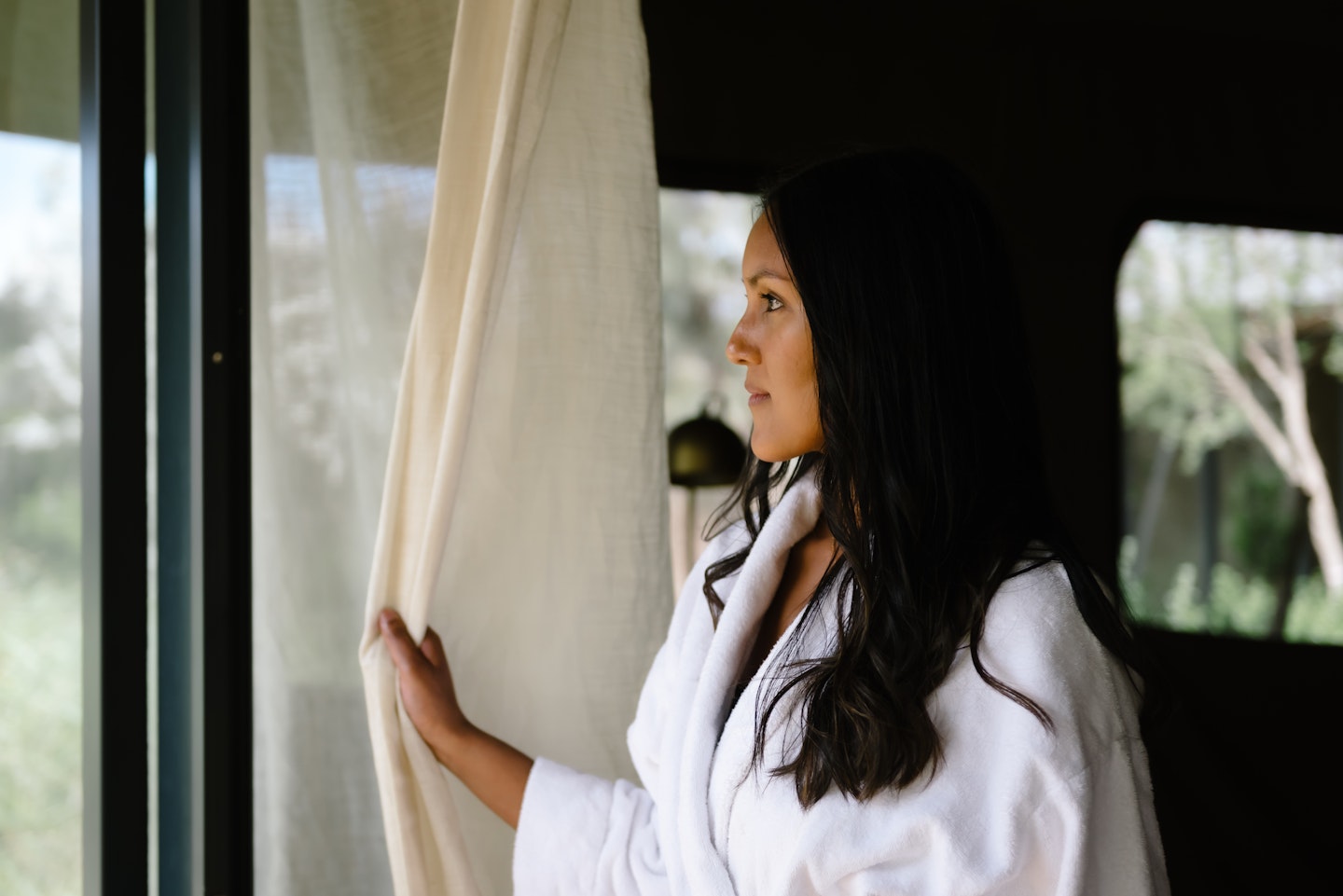 A girl looking out from the glamping tent