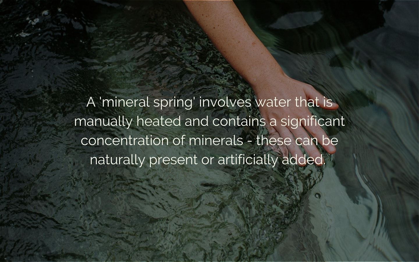 Text "A 'mineral spring' involves water that is manually heated and contains a significant concentration of minerals - these can be naturally present or artificially added" overlaying an image of water with a hand running through.