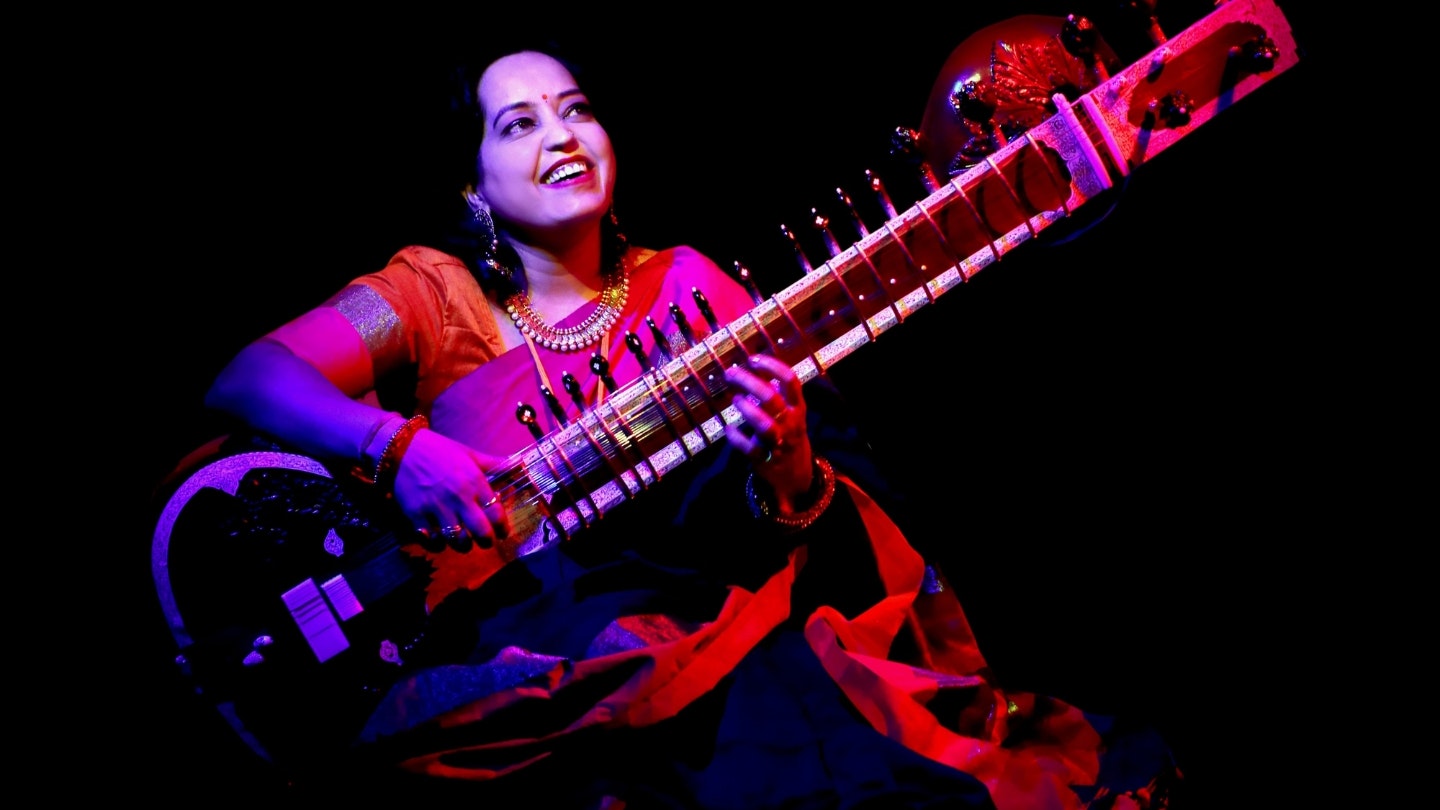 A woman playing a sitar
