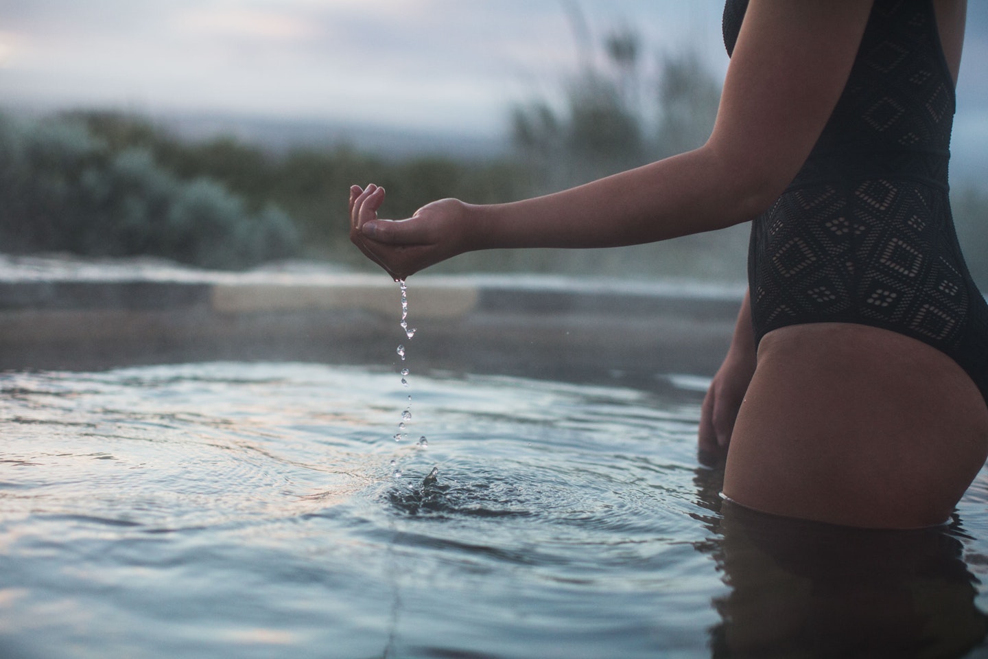 A woman moving water through her hands