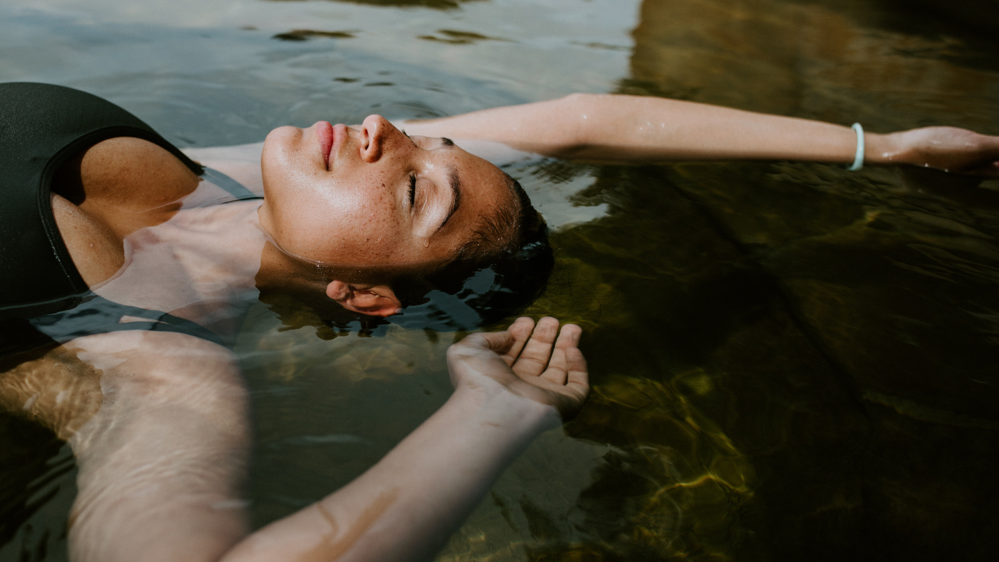 A woman floating on the surface of geothermal water