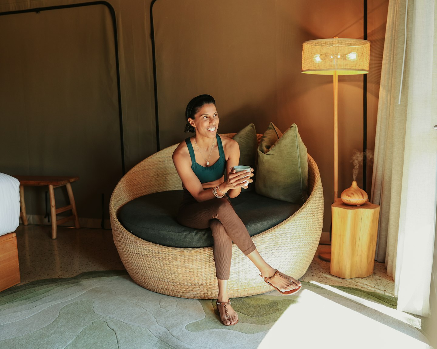 A person sitting on a chair in a Glamping tent