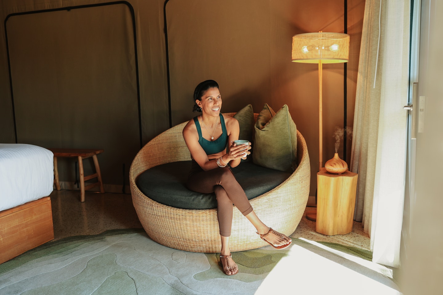 A person sitting on a chair in a Glamping tent