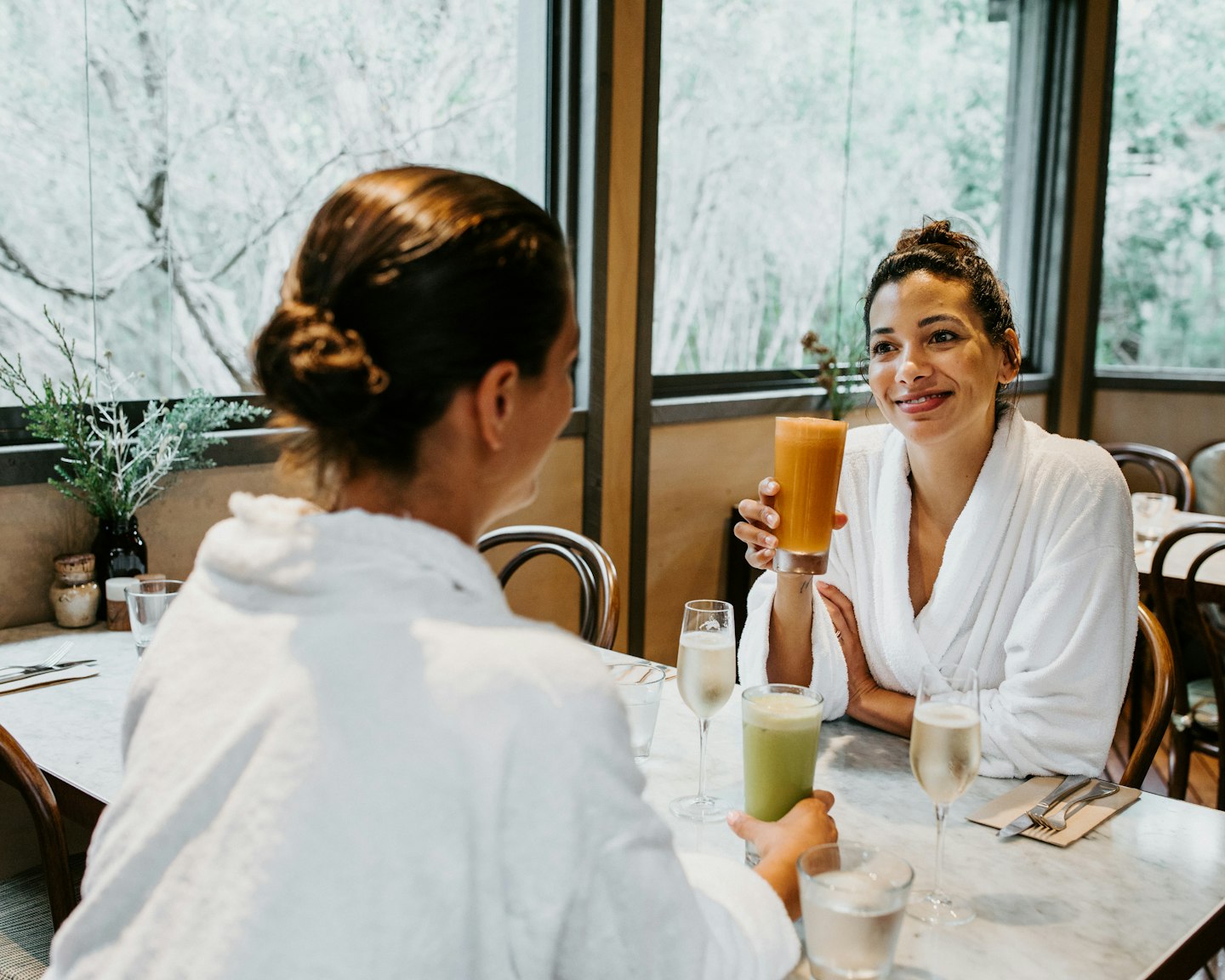 Two women in white robes enjoying breakfast in the Spa Dreaming Centre dining room