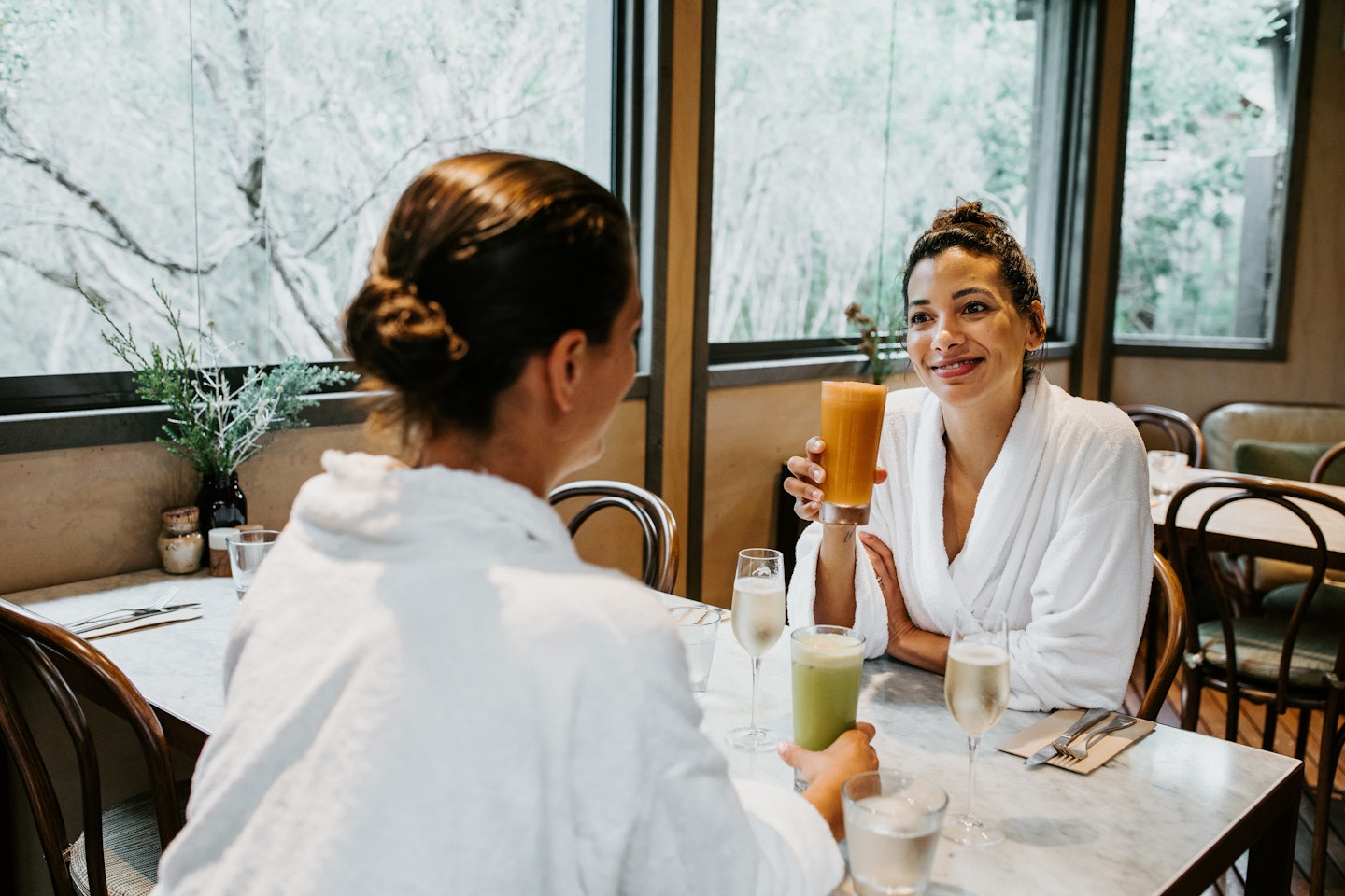 Two women in white robes enjoying breakfast in the Spa Dreaming Centre dining room
