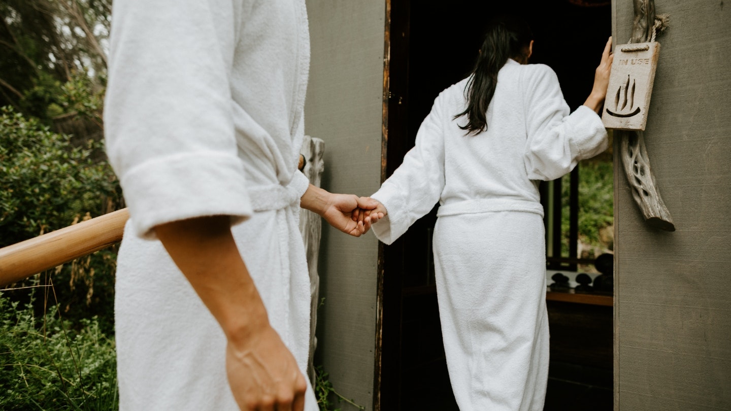 A man and a woman walking into a private bath