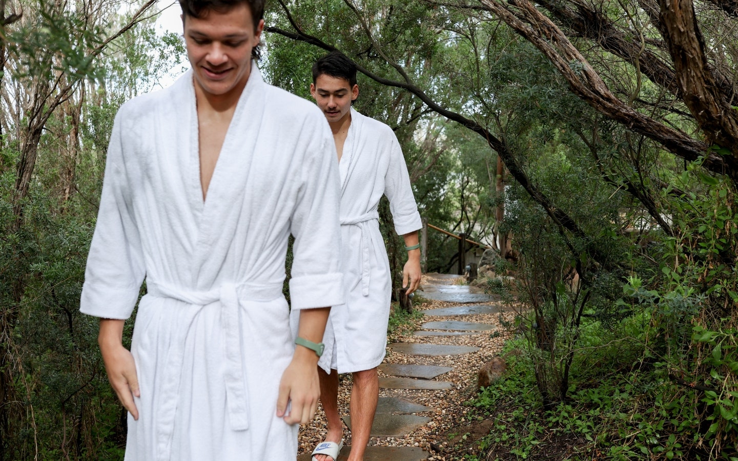 Two young boys in robes walking through the Spa Dreaming Centre