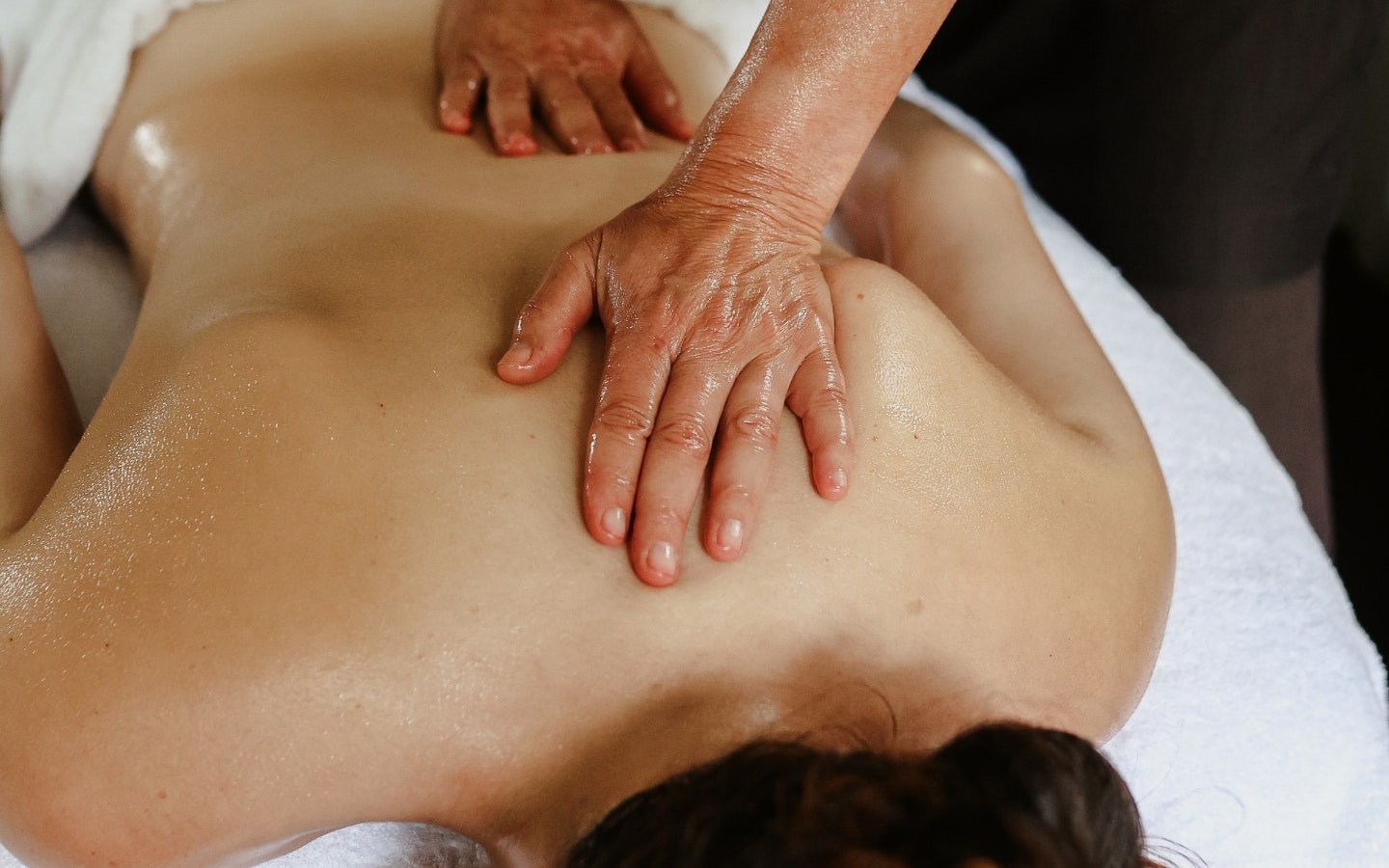 A woman receiving a back massage