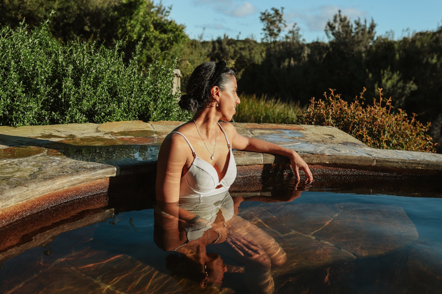 A woman bathing in geothermal springs