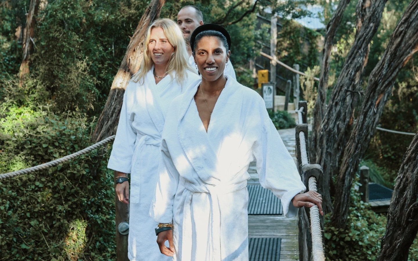 Three people walking the board walk of the Spa Dreaming Centre