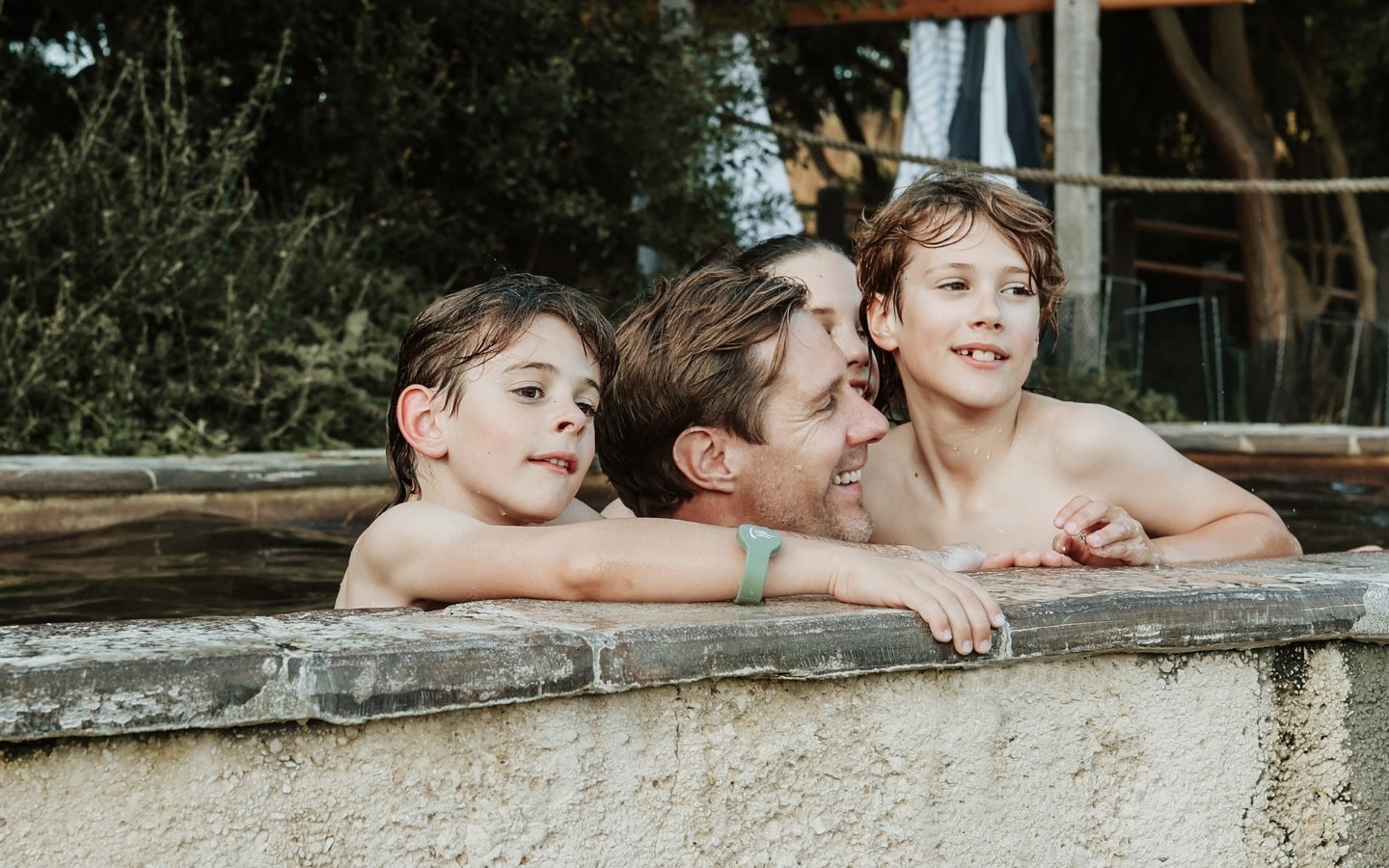 A father and three kids bathing in the Amphitheatre