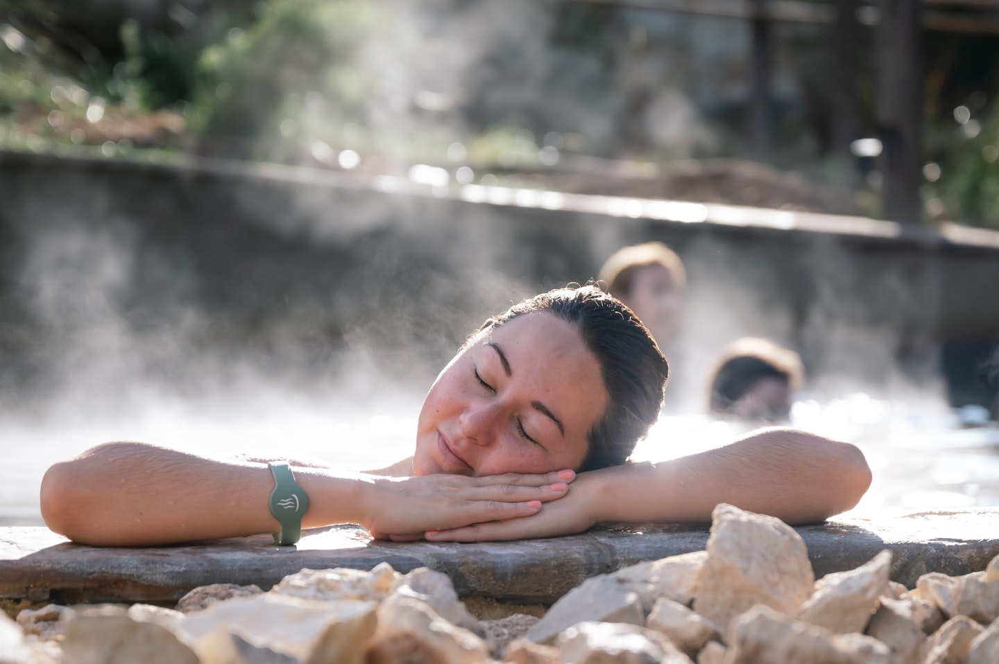 A woman bathing in hot springs during winter