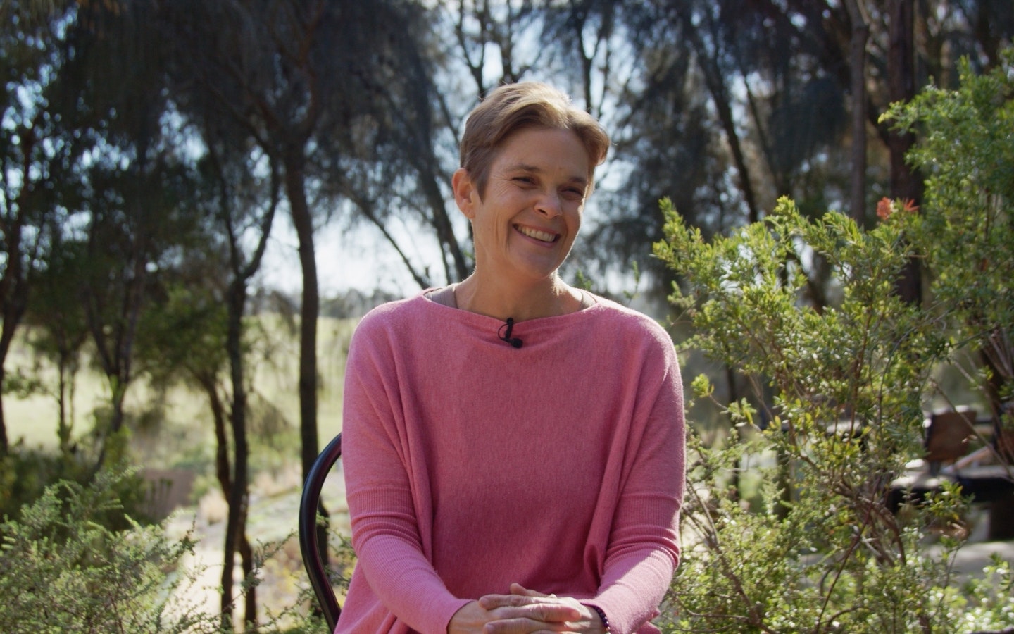 A woman laughing to camera