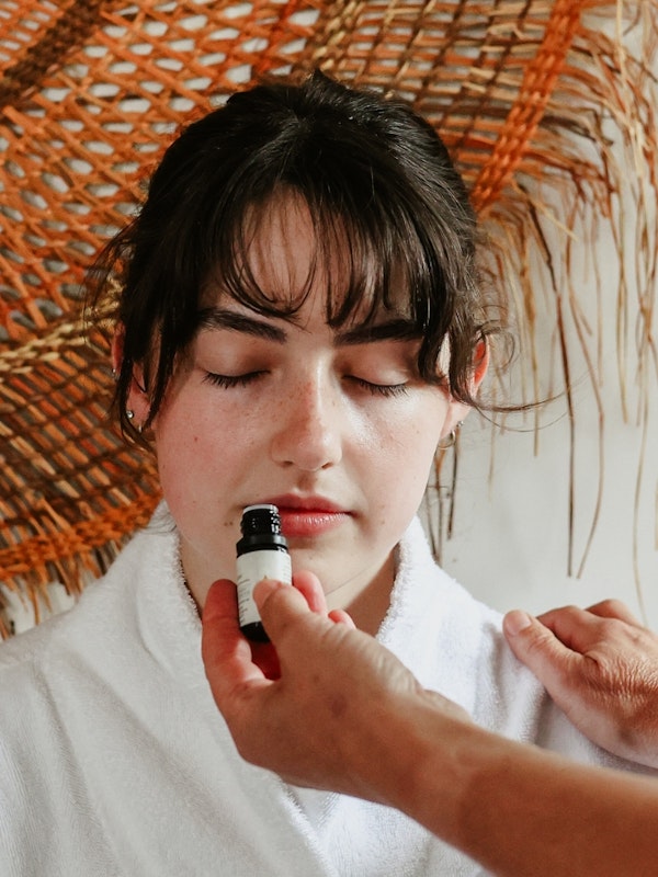 A person smelling essential oils