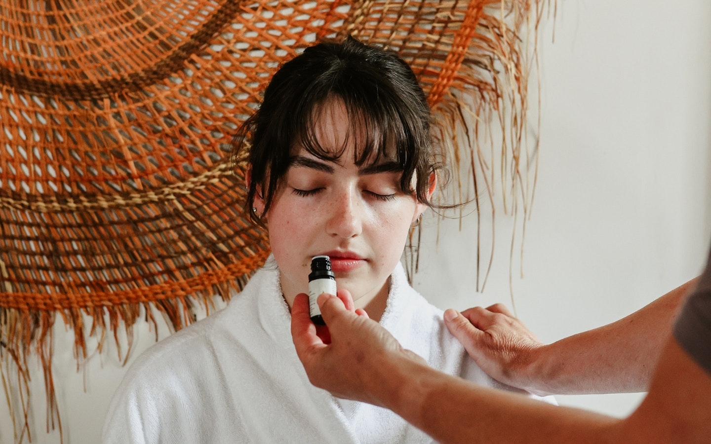 A person smelling essential oils