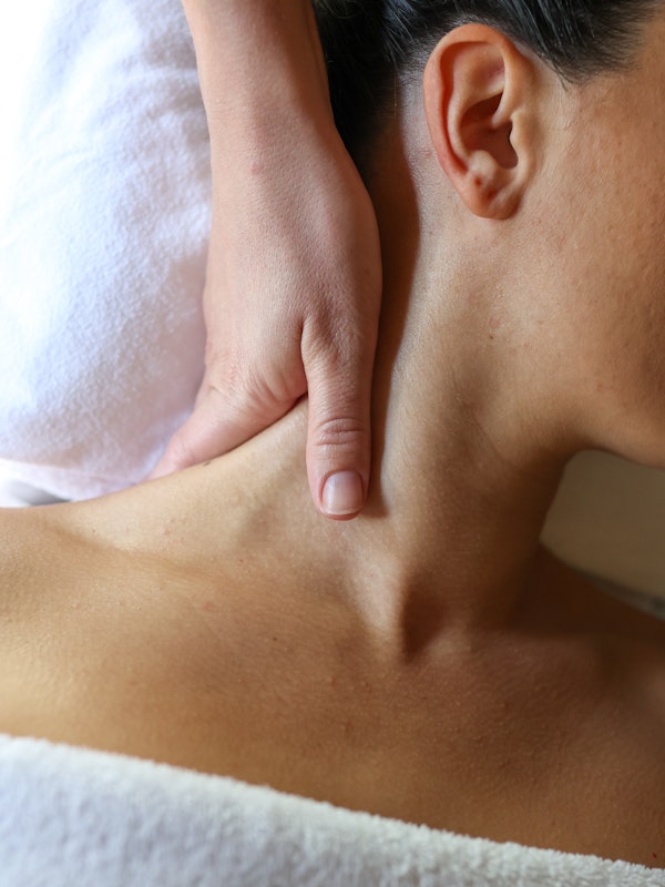 A woman receiving a neck massage